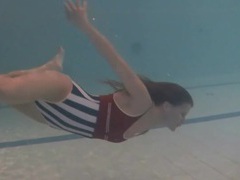 VidsPlus presents: Leggy girl swims and strips naked in pool